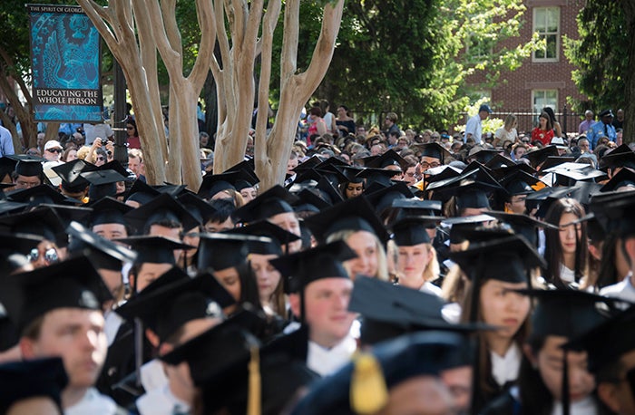 an audience of 2017 graduates shown from the tops of their heads 