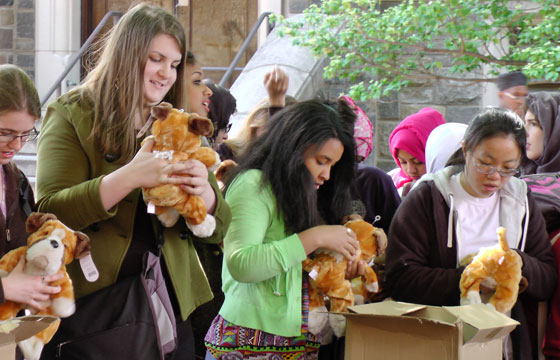 Students holding make-your-own bulldog toys in Red Square