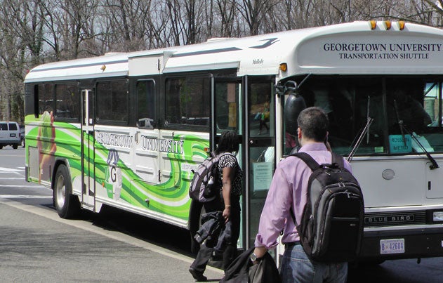 Student walk to enter a GUTS bus.