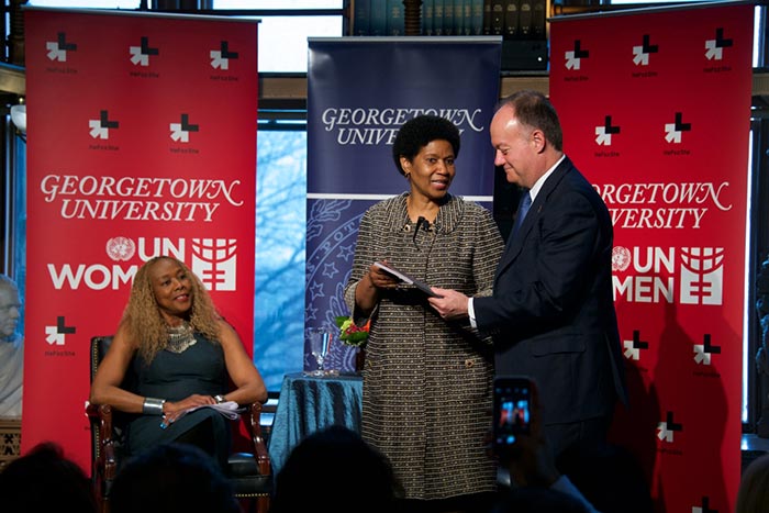 Phumzile Mlambo-Ngcuka talks with Georgetown President John J. DeGioia as Rosemary Kilkenny looks on.