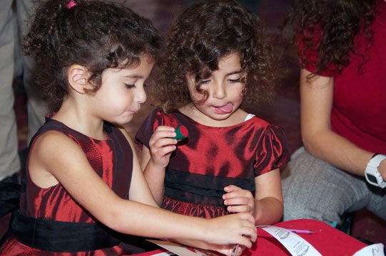 Serene and Samar Ramzy, daughters of Reem Saadeh-Haddad, assistant professor at the Georgetown Medical Center, stamp some art.