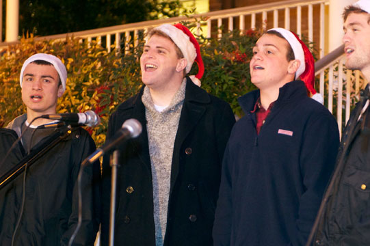 Members of The Georgetown Chimes, dressed in Santa hats, entertain with holiday songs.