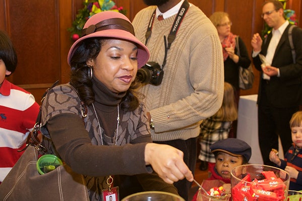 Brandy Baynes grabs candy from a display for her son who waits while her husband, Barrinton, has a camera around his neck behind