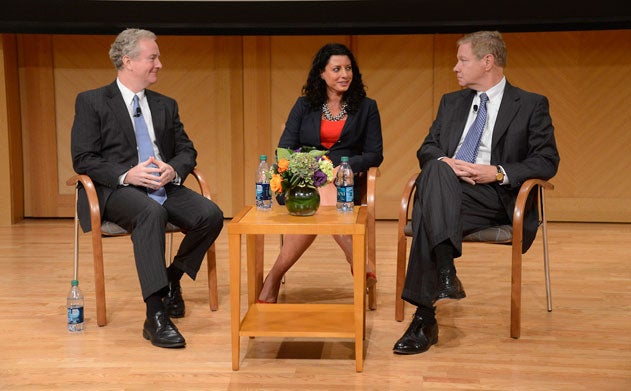 Chris Van Hollen, Heather Reilly, and Tom Davis sit on a panel in Lohrfink Auditorium