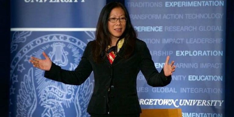 Mimi Ito speaks in front of a backdrop