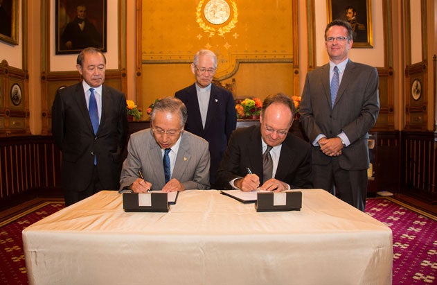 Tadashi Takizawa and John J. DeGioia sign a document in Philodemic Room with Ichiro Fujisaki, Toshiaki Koso and Tom Banchoff 