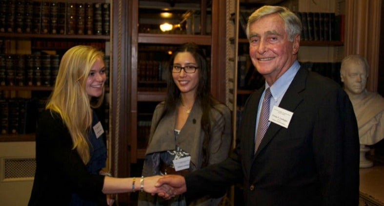 Breanna Donald shakes hands with George Landegger as Lena Adelita Landegger looks on in Riggs Library