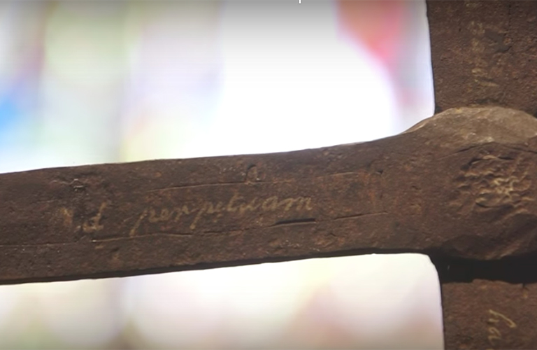 An arm of Georgetown's 17th century iron cross that will be part of a new Smithsonian exhibit with the words Ad perpetuam