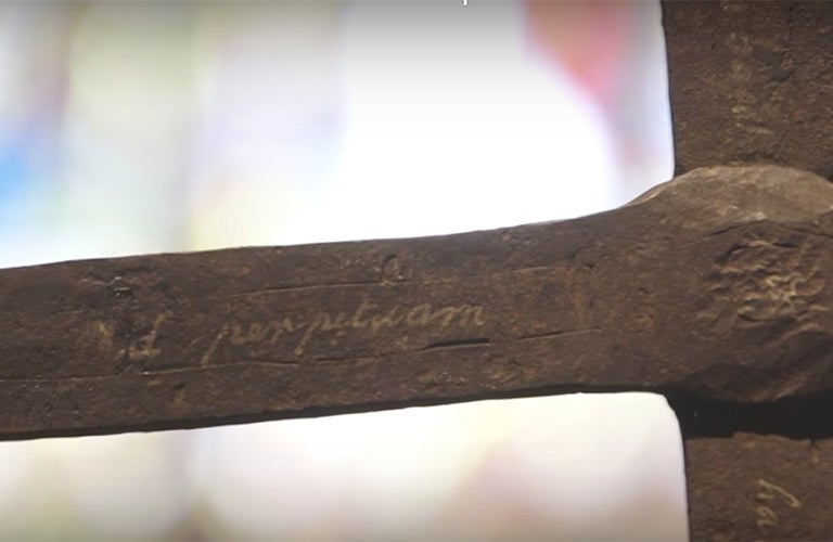 An arm of Georgetown's 17th century iron cross that will be part of a new Smithsonian exhibit with the words Ad perpetuam