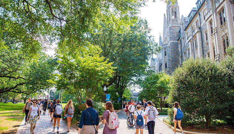 students walking near trees and building