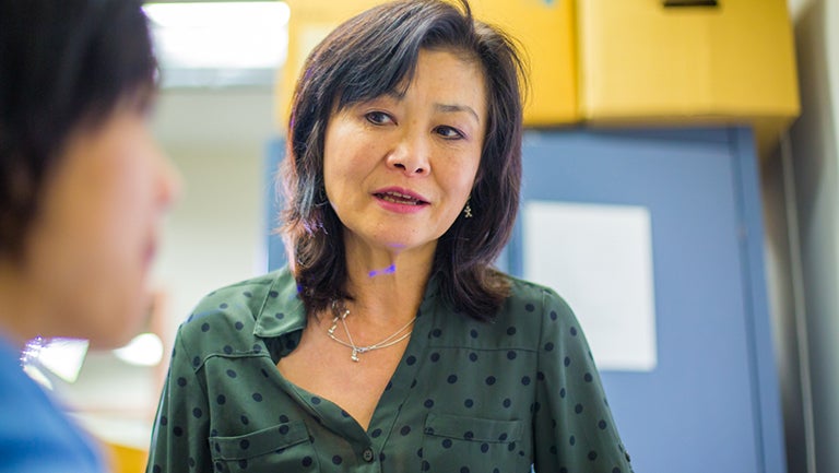 Chemistry professor Toshiko Ichiye talks to a student