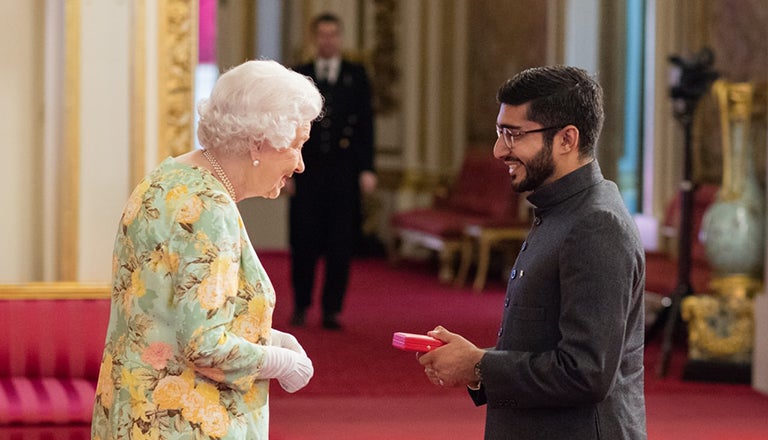 Haroon Yasin and the Queen of England in Buckingham Palace
