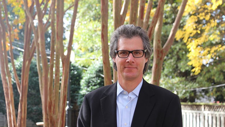 Keir Lieber standing outside with trees behind him