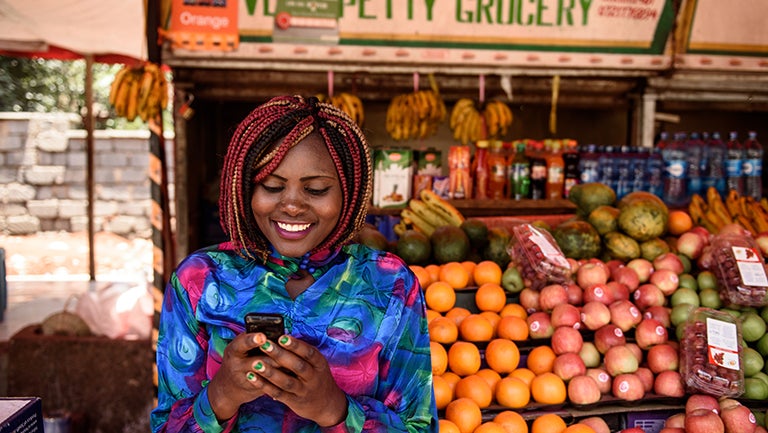 Woman using mobile money network in Kenya