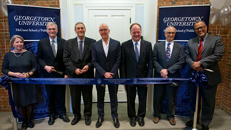 McCourt School, Georgetown leaders with U.S. Census representatives standing with ribbon to cut and open RDC