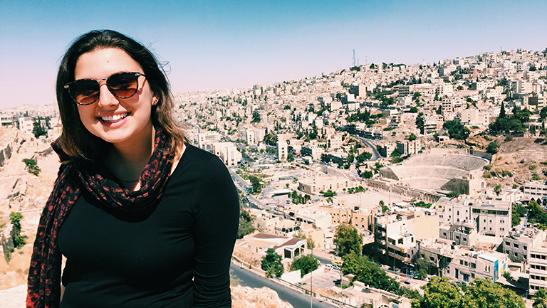 Margaret Crownover (SFS'18) wearing a scarf and sunglasses with Morocco buildings behind her