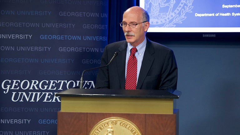 Phil Mendelson, chair of the District of Columbia Council, speaks into a microphone at The State of African Americans in DC.