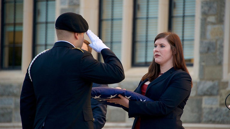 Cristine Starke, Georgetown’s Student Veteran Association president, delivers American flag to the ROTC Colors Sergeant 