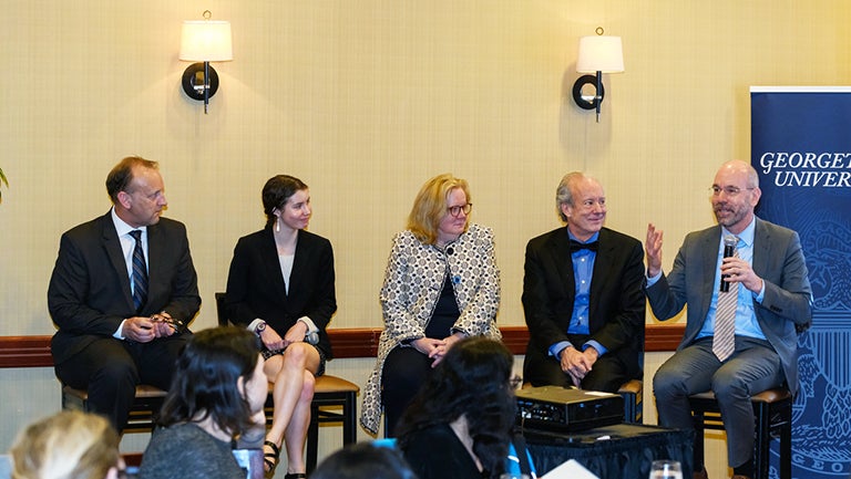 Sitting in chairs Robin Morey, Hannah Funk, Eugenie Dieck, William McDonough and Uwe Brandes, holding microphone