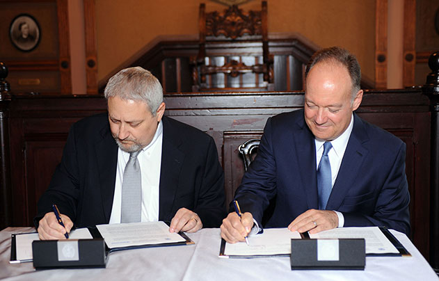 Bill Goldstein and John J. DeGioia sign partnership agreement in Philodemic Room