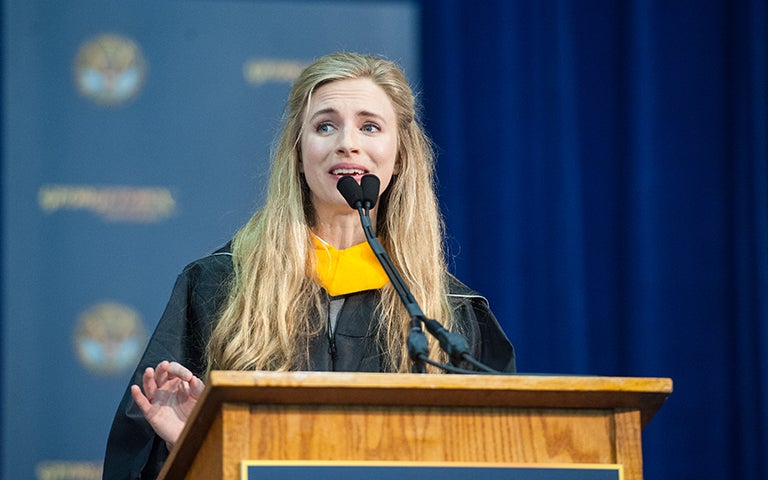 Britt Marling speaks in academic regalia during the Senior Convocation ceremony 