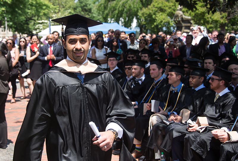 MBA graduate walks back to seat after receiving diploma