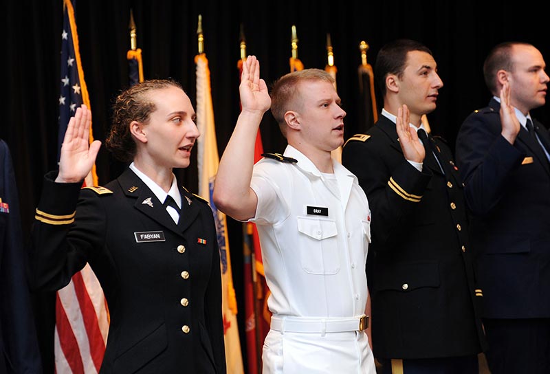 Graduarting medical students tak the oath during the Commissioning ceremony for medical school graduates.