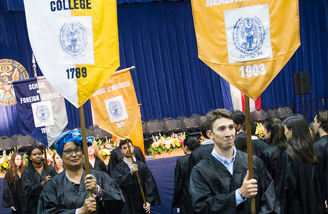Mélisande Short-Colomb brings in the Georgetown College banner along with other students representing the schools on campus.