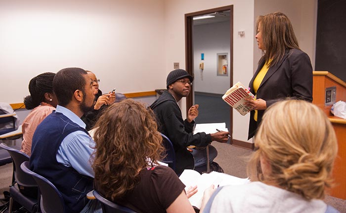 Angelyn Mitchell stands and speaks in front of students in a classroom