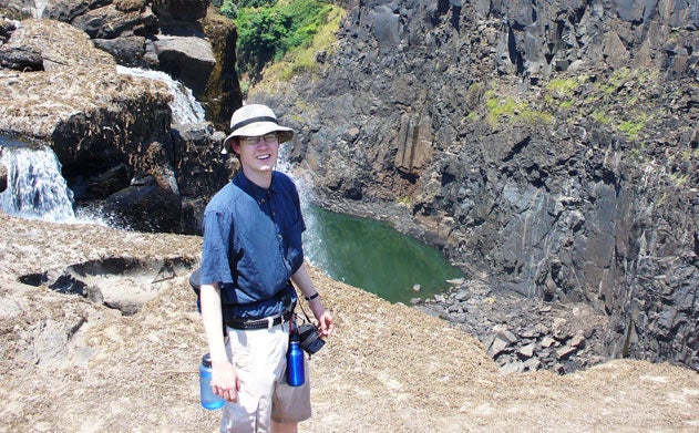 Eric Mooring stands near the edge of a piece of ground while visiting the Zambia side of Victoria Falls