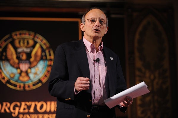 Bill Novelli with Georgetown seal behind him