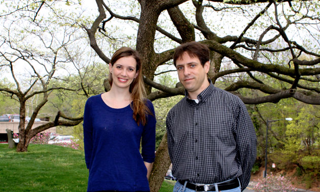Erika Raven and Scott Miles stand outside by a tree