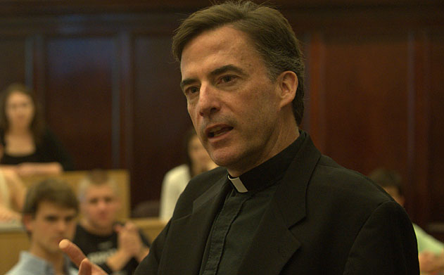 A closeup of Rev. Kevin O'Brien speaking to an audience.