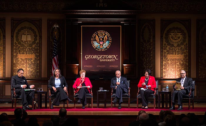 Maurice Jackson, Valerie Babb, Kathleen Lesko, Vernon Ricks Jr., Monica Roaché and Neville Waters III, speak on Gaston Hall.