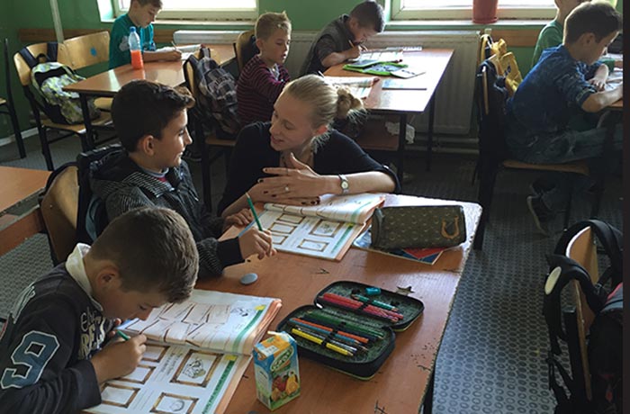 Peace Corps volunteer Zoe Mowl teaches young children in Kosovo classroom.