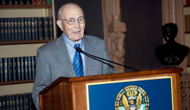 Edmund Pellegrino speaks to an audience from a podium.