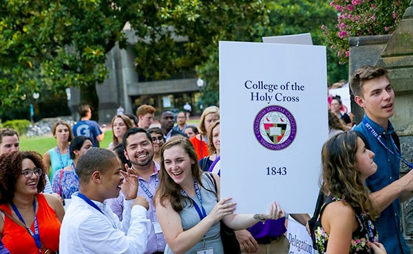 Students from Holy Cross walk into Healy Hall during the leadership conference processional 