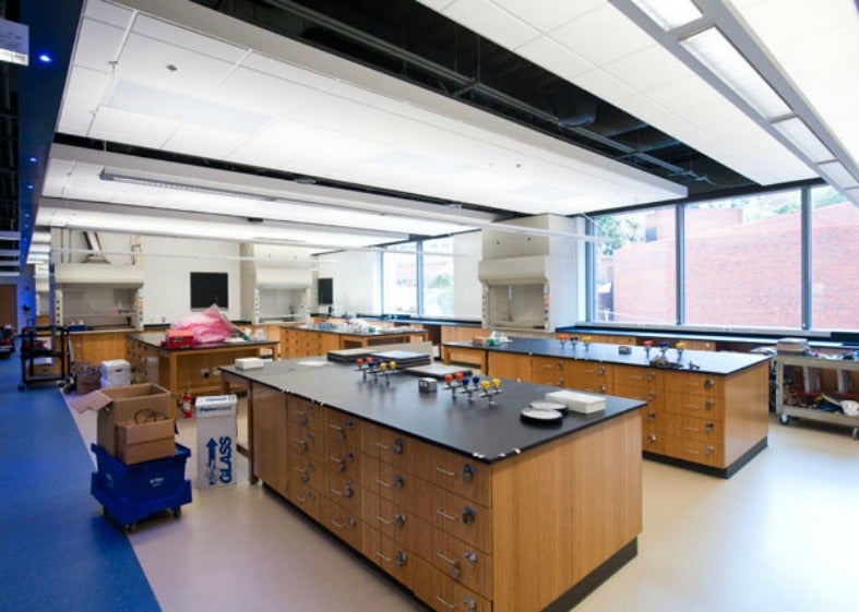 A lab shows tables and equipment in a brightly lit space