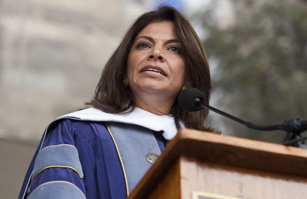 Laura Chincilla looks out at the crowd while speaking behind a podium