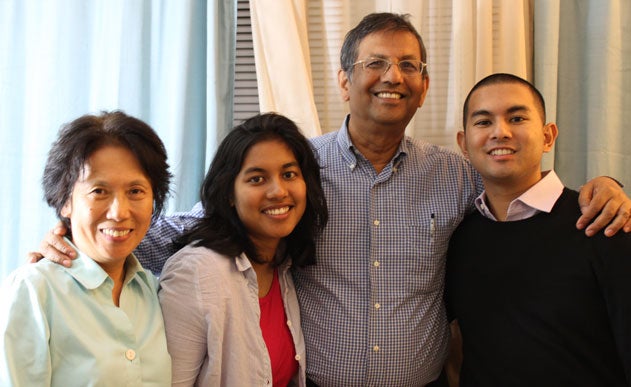 Indra Sen with his arms around his family; mother Susan, sister Maya and father Pabitra
