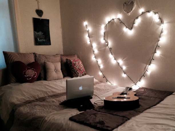 String lights beside a dorm-room bed.