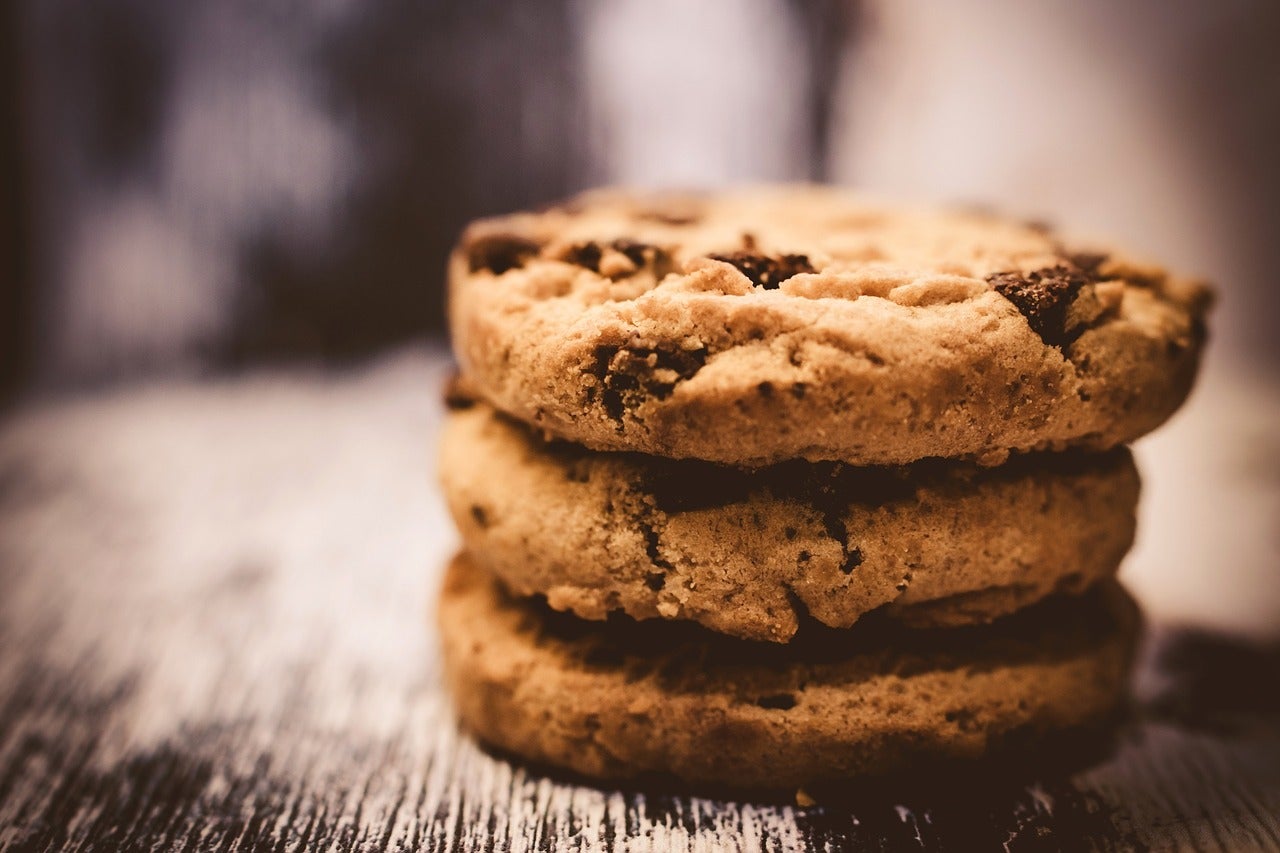 A stack of cookies in the foreground of the frame