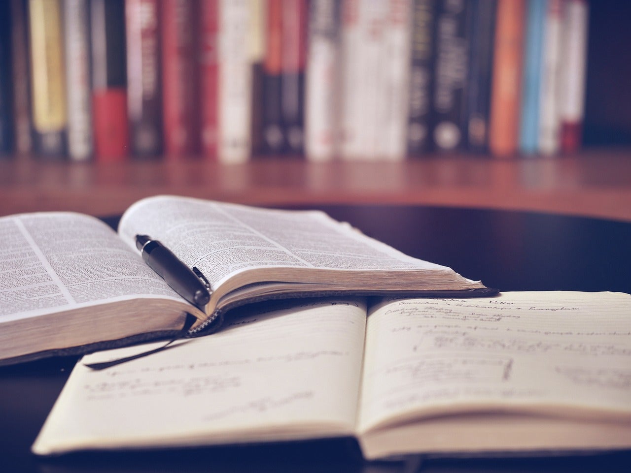 Open books sit on a desk in a library