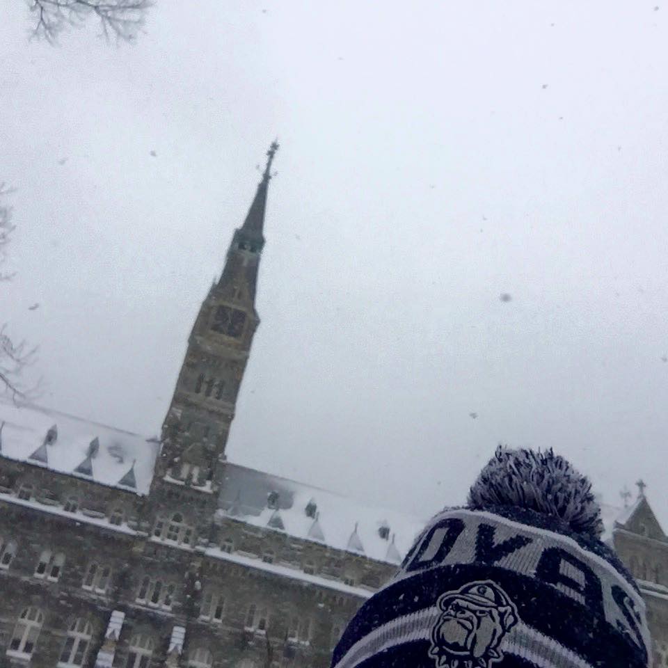 A Georgetown hat peeks into the frame on a snowy day