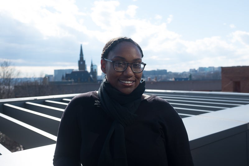 Professor Marcia Chatelain smiles for the camera on a rooftop. 