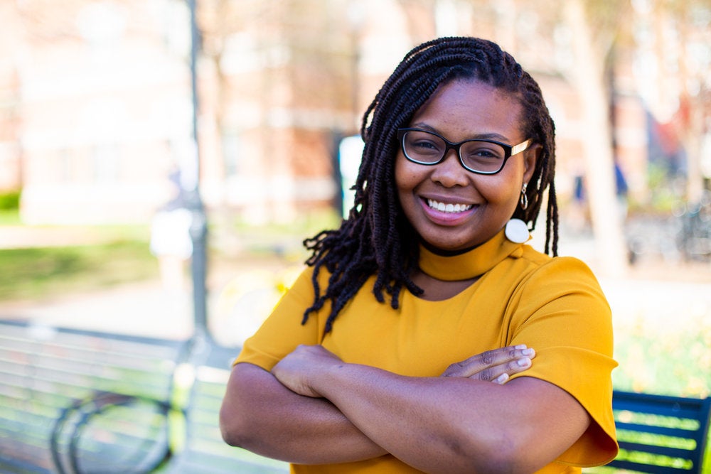 Toddchelle Young smiles for the camera with her arms crossed.