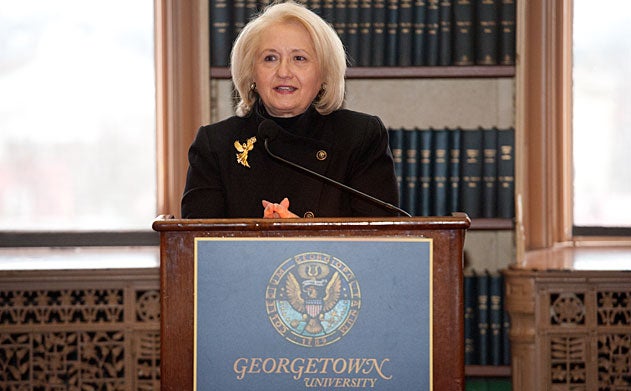 Melanne Verveer speaks at Georgetown University podium in library