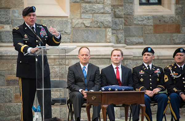 Lt. Gen. H.R. McMaster and Georgetown President DeGioia sit and listen to a speaker onstage during the ceremony.