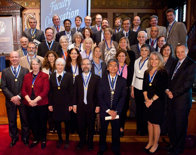 2012 Vicennial Medal Recipients standing on the steps of the Gaston Hall stage